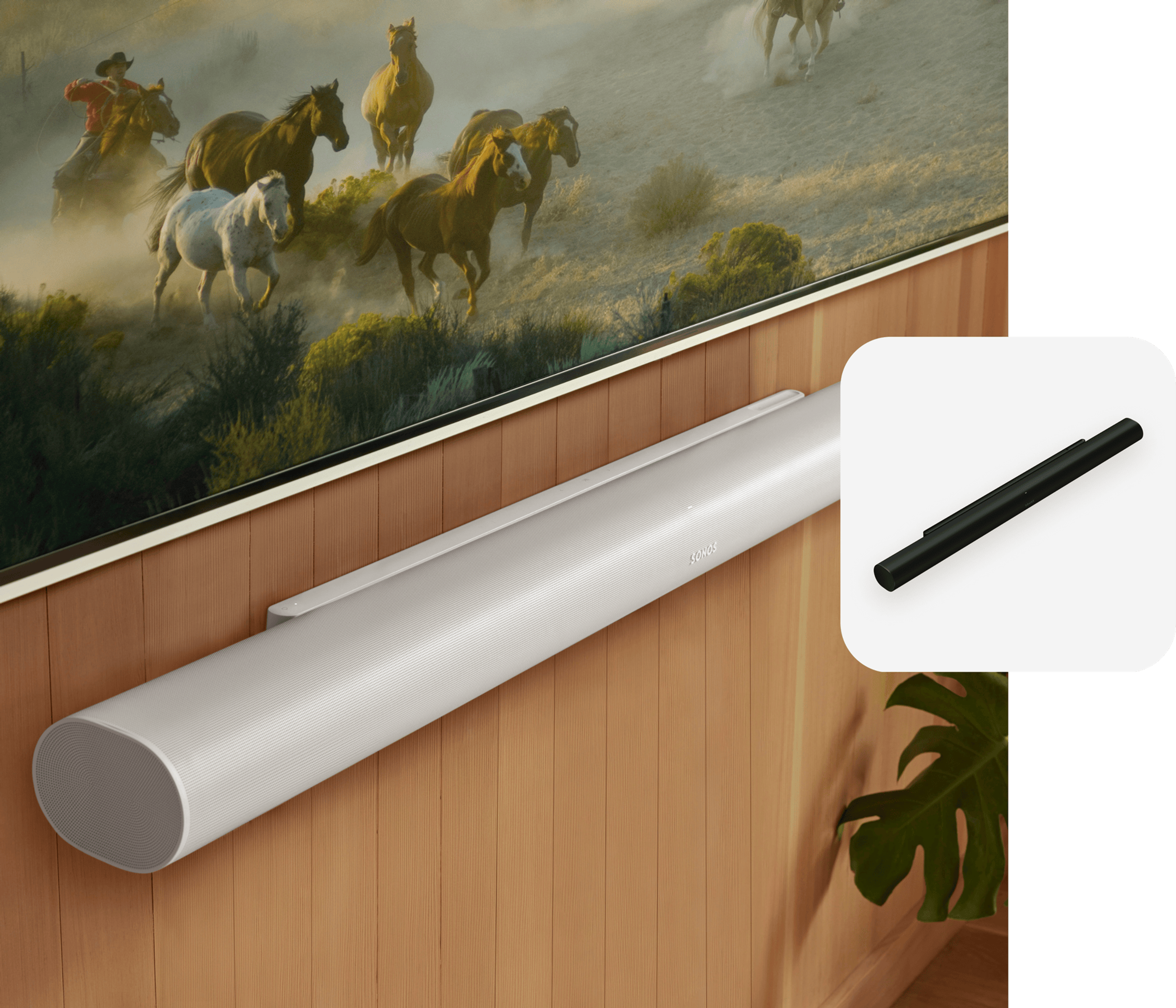 Closeup of a white Arc Ultra mounted to a wood-paneled wall below a TV and a black Arc Ultra product tile overlay