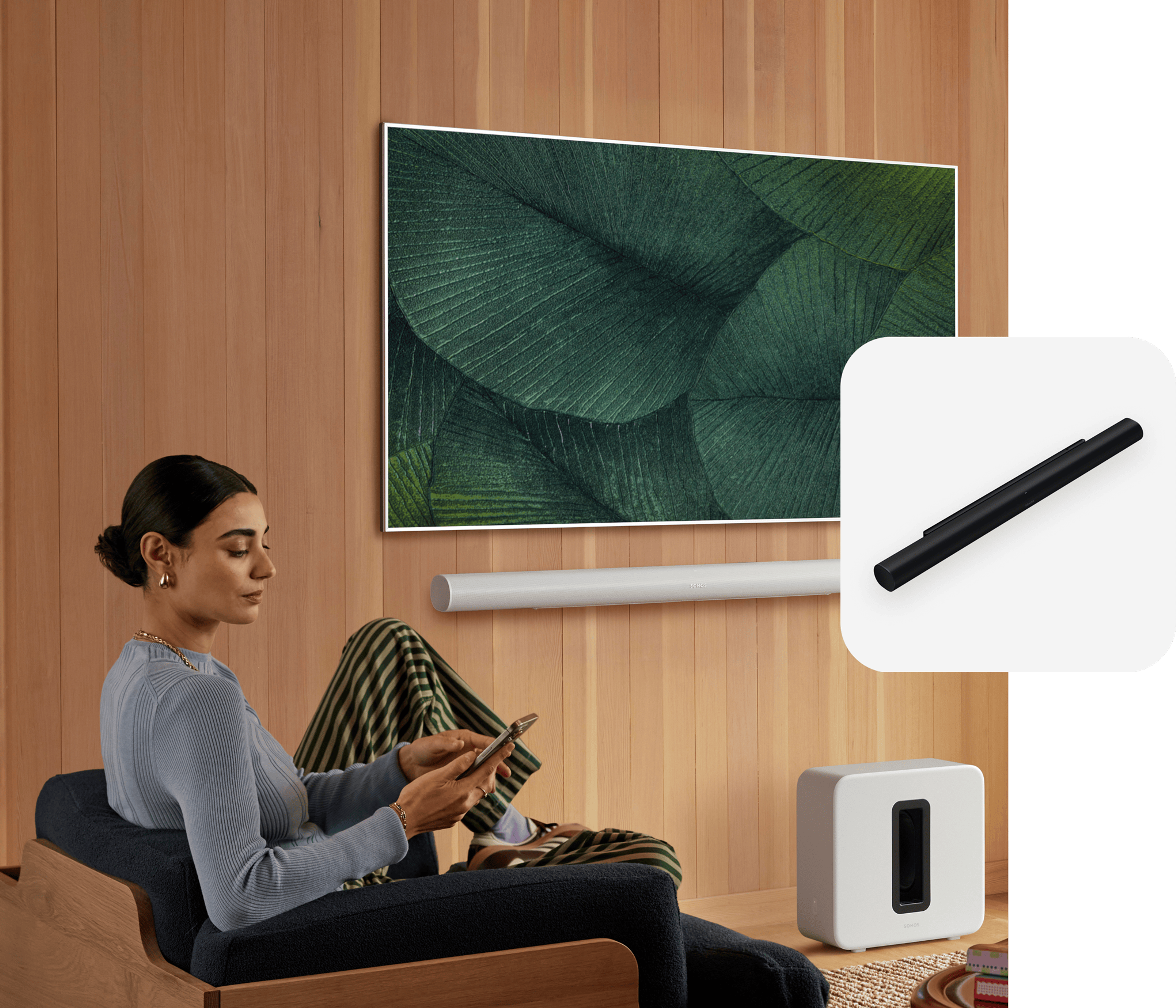 Person sitting and using a phone with Sonos Arc Ultra and TV in the background and a Arc Ultra product tile overlay