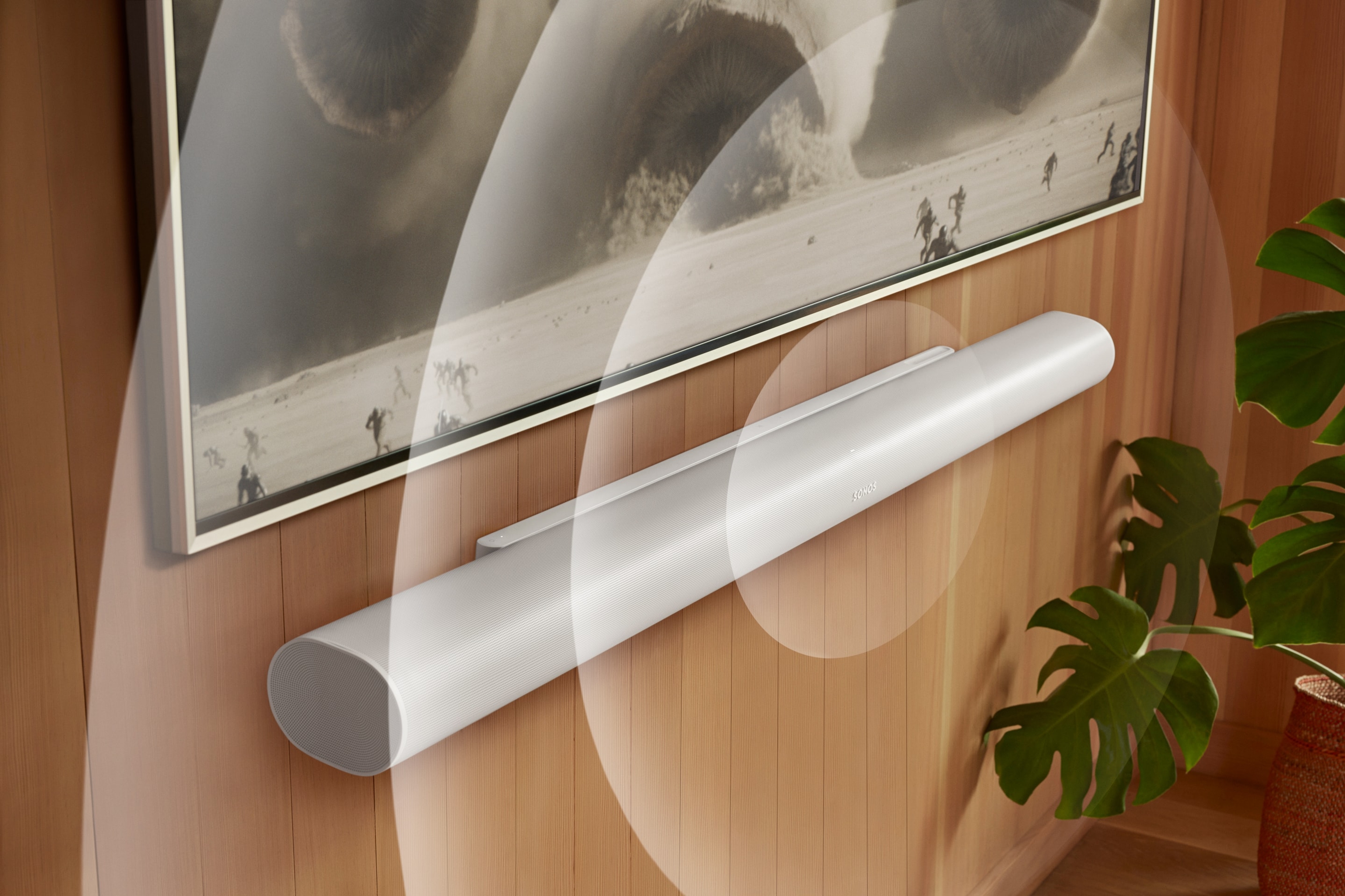 A white Arc Ultra mounted below a TV with animated soundwaves and screen content from Dune 2