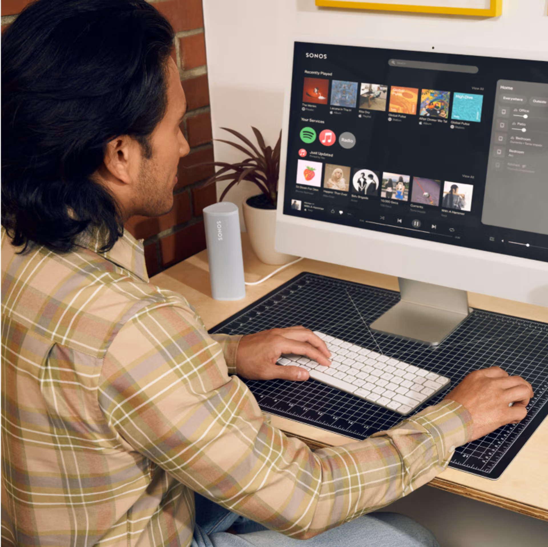 A computer with the Sonos Web app open in a web browser